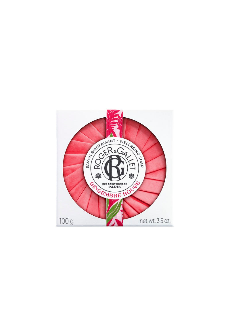 A bar of Roger & Gallet Red Ginger scented wellbeing soap in round packaging, featuring a prominent dark logo and text against a vibrant red and white striped background.