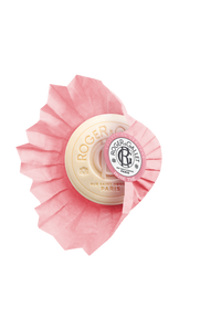 A luxurious Roger & Gallet Rose Wellbeing Soap in an artfully designed round tin with a pink floral motif and sparkling diamond-like accents around the central logo.