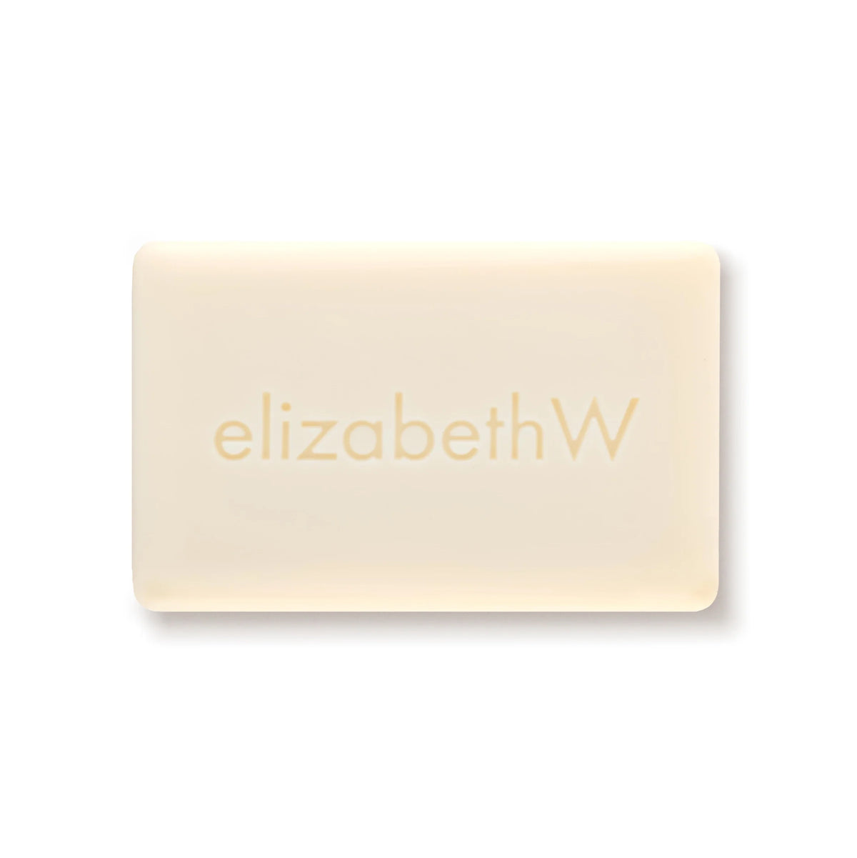 The elizabeth W Botanist's Scent Lab Leaves Bar Soap is a rectangular, off-white bar embossed with "elizabethW," inspired by the Botanist's Scent Lab, capturing natural freshness against a plain white background.