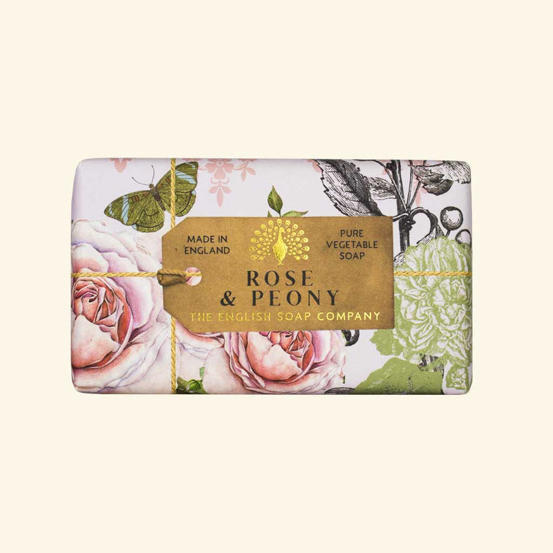 A rectangular The English Soap Co. Anniversary Rose & Peony soap package from The English Soap Company, labeled "Rose & Peony" with elegant floral designs, featuring pink roses and green leaves, emphasizing its vegetable-based ingredients.