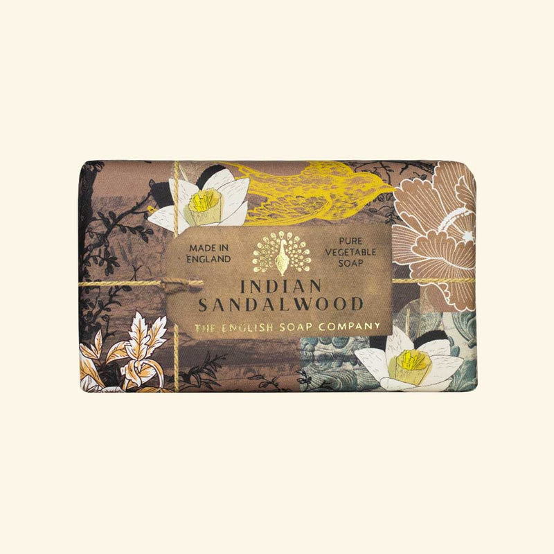 A bar of The English Soap Co. Anniversary Indian Sandalwood soap from The English Soap Co., featuring a floral design with gold accents on the packaging, emphasizing its vegan friendly, pure vegetable soap composition.