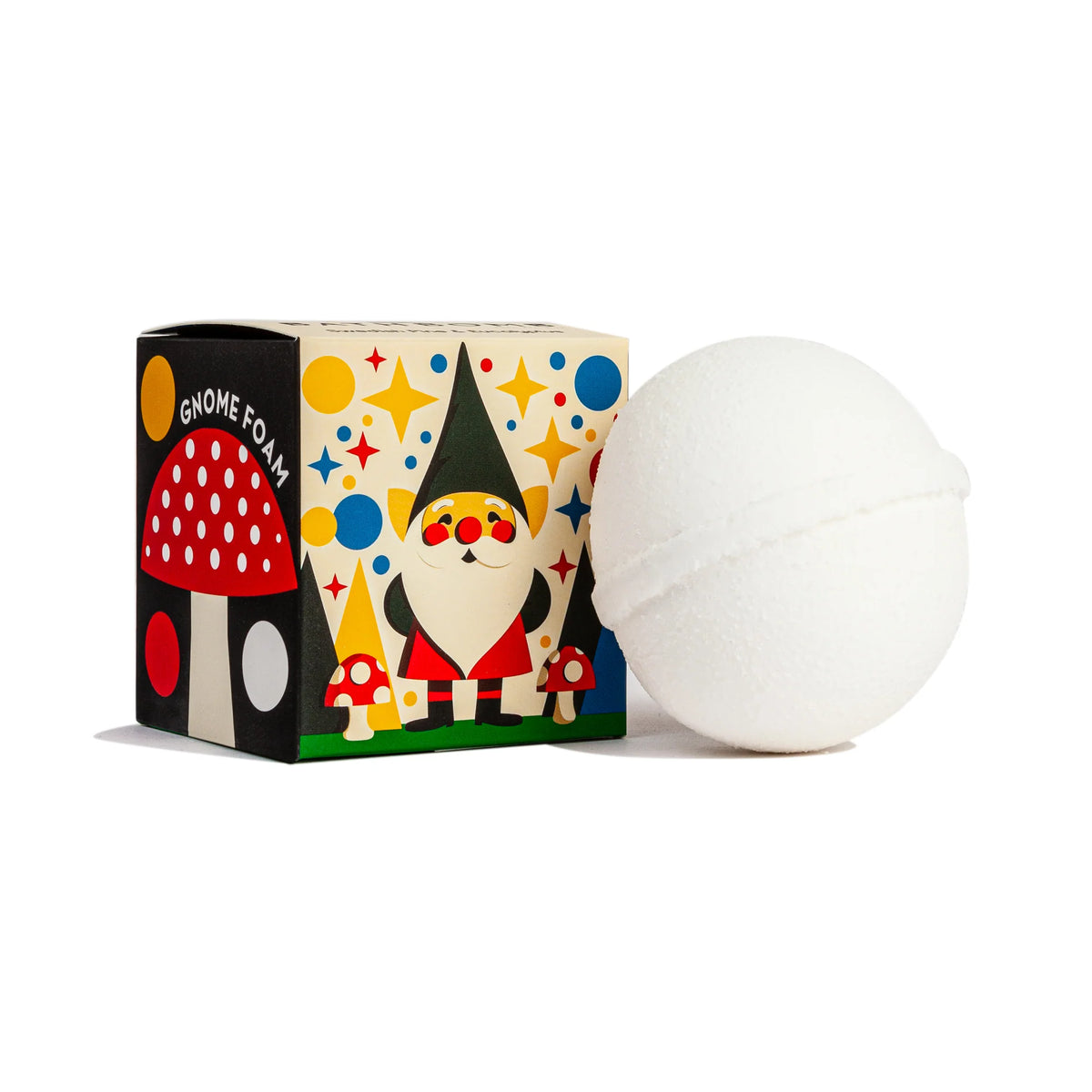 A white Swedish Dream Gnome Foam™ Swedish Pine Bath Bomb by Kala sits beside a colorful box with a smiling gnome in a blue hat, red mushrooms, and playful circles and stars. The box notes it contains organic eucalyptus oil.