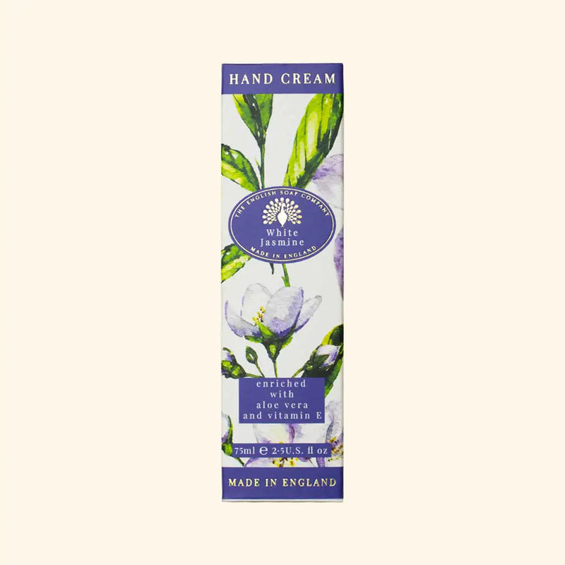 A rectangular box of The English Soap Co. White Jasmine Hand Cream adorned with an illustration of white jasmine flowers and green leaves. The text mentions it is enriched with aloe vera, shea butter, and vitamin E and measures 75 ml (2.5 US fl. oz). The label indicates it is made in England.