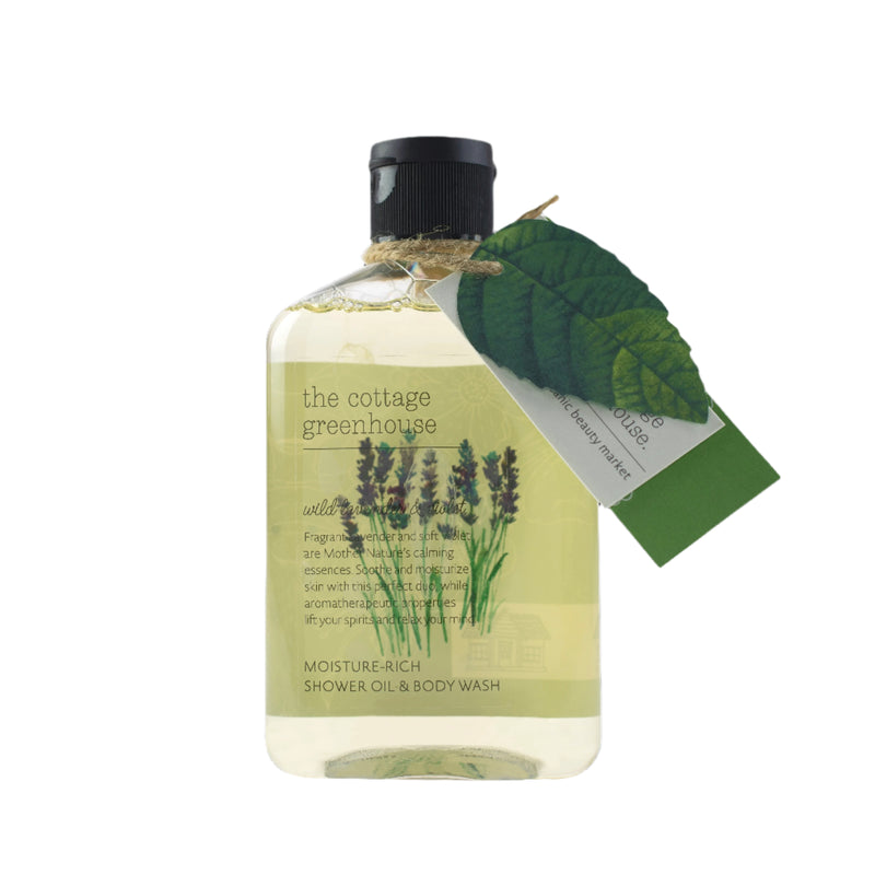 The Margot Elena Cottage Greenhouse Wild Lavender & Violet Body Wash features lavender flower illustrations, a black cap, and a leafy decorative tag on the neck, providing soothing aromatherapeutic properties for a tranquil bathing experience.