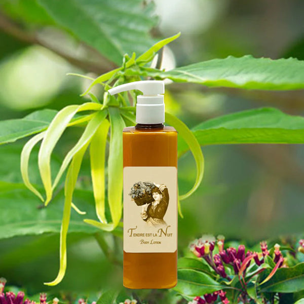 A pump bottle of La Bouquetiere Tendre est la Nuit Body Lotion, featuring a vintage-style label, is pictured among green leaves and pink flowers, conveying youthful elasticity in a natural outdoor setting.