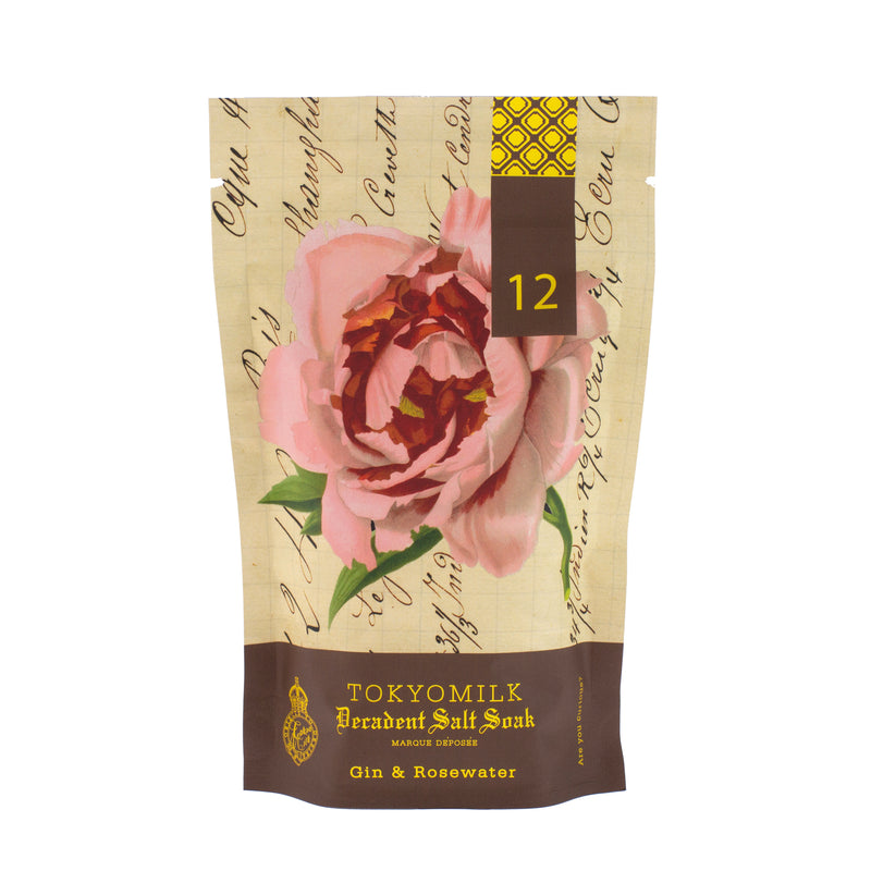A package of Margot Elena TokyoMilk Gin & Rosewater Salt Soak featuring a pink rose on a beige background with cursive and print writing, and a dark brown bottom section.