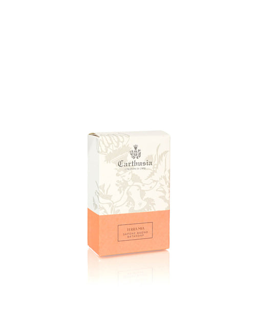 A rectangular Carthusia Terra Mia Bar Soap box by Carthusia I Profumi di Capri features a white floral top, peach lower half, and text highlighting this artisanal bar soap’s Mediterranean-inspired fragrance.