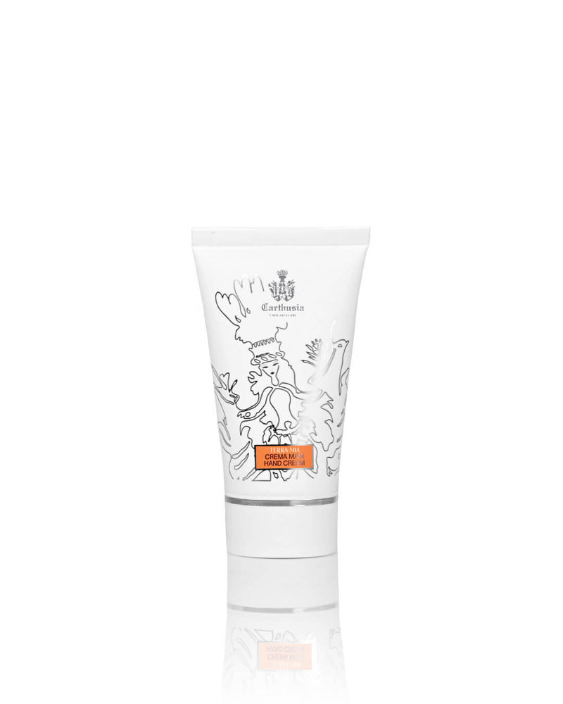 A white tube of Carthusia I Profumi di Capri Terra Mia Hand Cream, decorated with black-outlined floral and bird designs and an orange label, promises Mediterranean-inspired skincare against a plain white background.