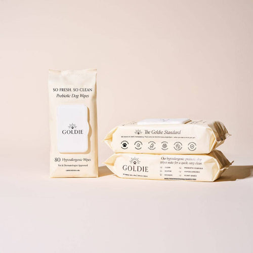 Three beige packs of Goldie - So Fresh, So Clean Probiotic Wipes are displayed on a light beige background, showcasing these gentle, hypoallergenic wipes—ideal for incorporating into your dog's daily grooming routine.