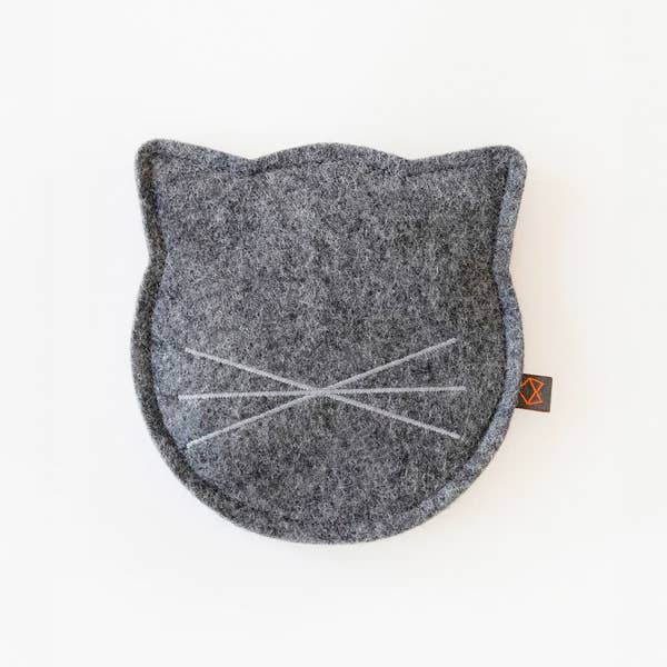 The MODERNBEAST - CITY CAT Toy with Organic Catnip is a round, gray wool felt cat mat shaped like a cat's head, featuring stitched whiskers and no other facial features.
