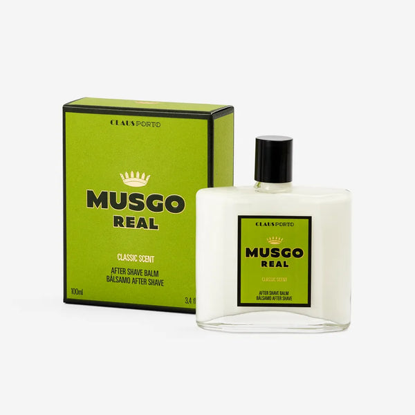 A rectangular bottle of Claus Porto 1887 Musgo Real Classic Scent After Shave Balm with shea butter and a black cap sits beside its matching green and black box labeled "Classic Scent" and "100 ml," both featuring the Claus Porto logo and crown icon.