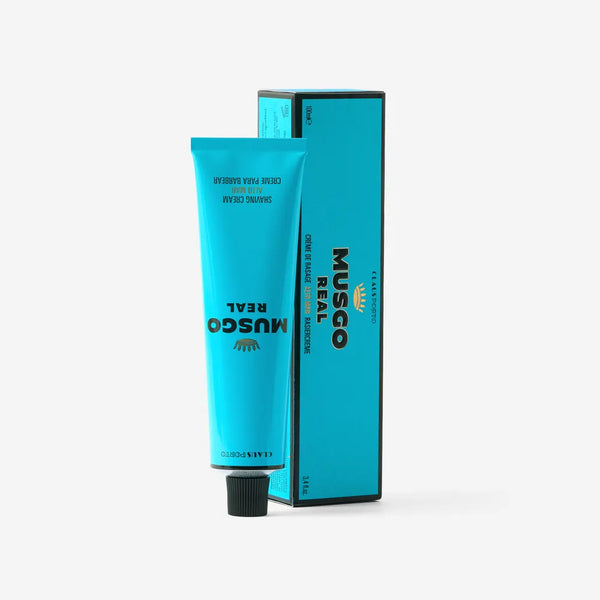 A turquoise tube of Claus Porto Musgo Real Alto Mar Shaving Cream by Claus Porto 1887 stands upright beside its matching box, both featuring bold black text on a plain white background—a refined men’s grooming choice.