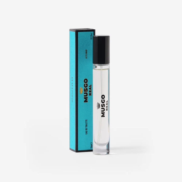 A clear glass bottle of Claus Porto 1887 Musgo Real Alto Mar Eau de Toilette Travel Size stands beside its blue and black box on a white background, showcasing this iconic Portuguese fragrance.
