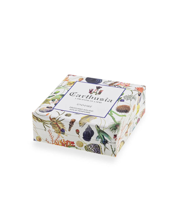 A decorative Carthusia I Profumi de Capri A'mmare Solid Perfume box with botanical flower and plant illustrations on white, featuring the brand name and product details—ideal for luxury fragrance lovers and Capri fans.