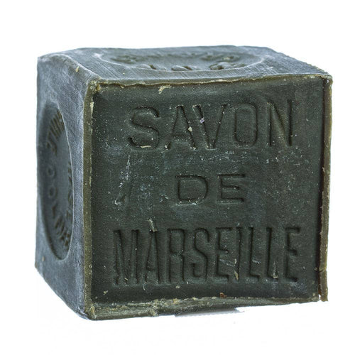The FRENCH SOAPS Savon de Marseille Olive Oil Soap Original (600g) is a square, olive green bar with "SAVON DE MARSEILLE" embossed, featuring a rustic texture, slightly worn edges, and a gentle, hypoallergenic formula.