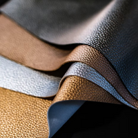 Metallic silver, gold, and bronze textured faux leather sheets overlap in waves, echoing the rich layers of ISULA parfums Banditu eaux de parfum—a sophisticated Corsican scent from ISULA parfums with woody notes.