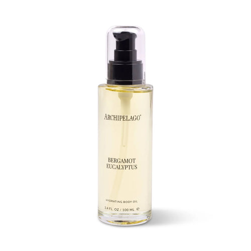 A clear bottle of Archipelago Botanicals Bergamot Eucalyptus Hydrating Body Oil with a black pump and transparent cap, containing 3.4 fl oz (100 ml) of yellow-tinted natural body oil.