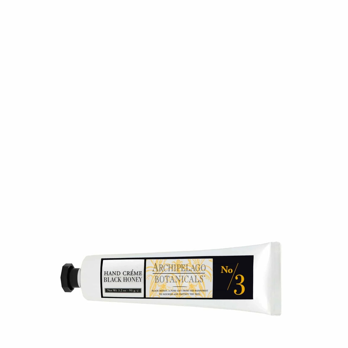 A white tube of Archipelago Black Honey Hand Crème by Archipelago Botanicals, with black and yellow labels, lies horizontally on a white background. This hand cream features Amazonian Black Honey for soft, hydrated skin.