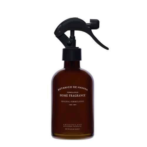 A brown glass spray bottle labeled "Archipelago Botanico de Havana Room Spray" by Archipelago Botanicals, with notes of Tobacco Flower and Bergamot and a black trigger nozzle, stands against a white background.