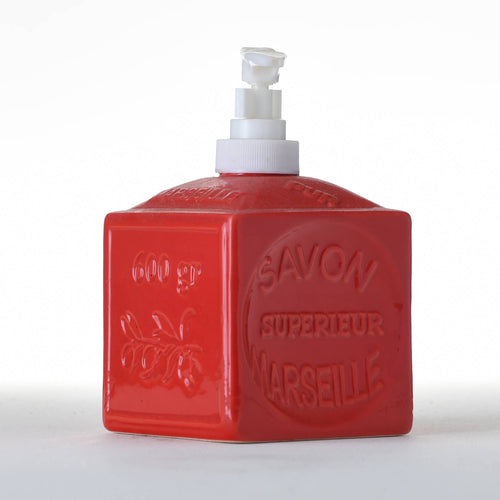 A red, square-shaped ceramic soap dispenser with a pump top, branded as FRENCH SOAPS' French Soaps Liquid Soap Dispenser Savon de Marseille. The bottle features raised text that reads "Savon Superieur Marseille" on the front, along with a decorative floral design. Its traditional charm is enhanced by the plain white background, making this Savon de Marseille dispenser the focal point.