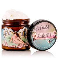 A jar of Barefoot Venus The Vanilla Effect Instant Hand Repair Balm with its lid off displays a vintage-style label portraying a winged woman encircled by roses. This natural blend not only impresses with its design but also promises to nourish and heal your skin, while cream is visible inside the intricately adorned lid.