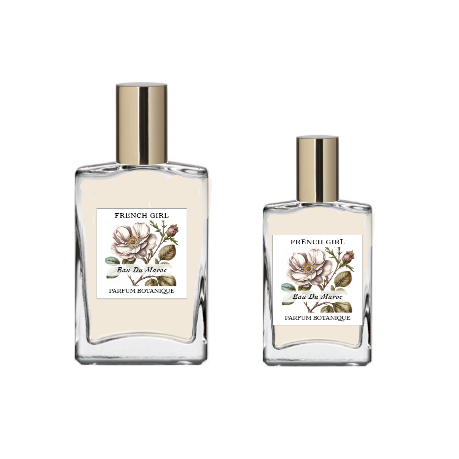Two glass bottles labeled "FRENCH GIRL Eau Du Maroc Organic Vegan Natural Aromatherapy Perfume," featuring floral illustrations and gold caps, display this alcohol-free vegan scent made with essential oils, set against a plain white background.