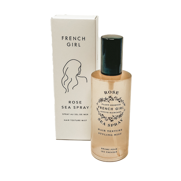 A bottle of FRENCH GIRL Organic Sea Salt Hair Mist & Texturizing Spray – Rose stands before its white box, which features a minimalist line drawing and black text. This spray is ideal for creating effortless beachy waves.