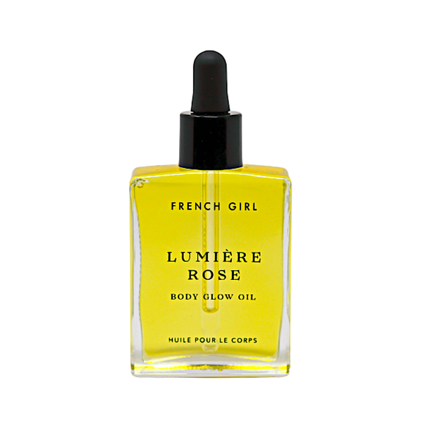 A square glass bottle of FRENCH GIRL Organic Hydrating Rose Body Oil (2 oz) with a black dropper cap, filled with yellow oil. The label features the brand and product name in black text.