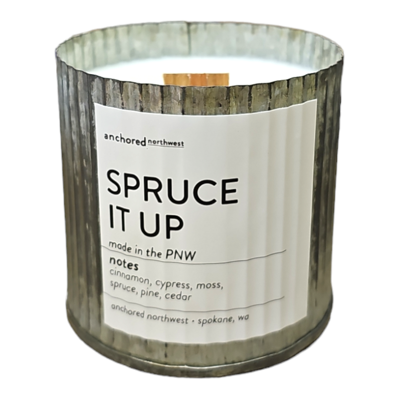 The "Anchored Northwest Spruce It up Rustic Vintage Farmhouse Wood Wick Candle" by Anchored Northwest is a metal container candle made in the PNW, featuring a wood wick that enhances its rustic and minimalist aesthetic. Its soy wax formula emits scent notes of cinnamon, cypress, moss, and spruce, making it ideal for farmhouse decor enthusiasts.