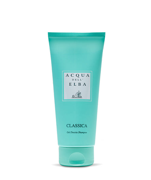 A turquoise tube of Acqua dell’Elba Classica Uomo Body Lotion, adorned with a white label with navy text and a sailboat illustration, stands upright against a plain white background, reflecting its signature marine-inspired elegance.