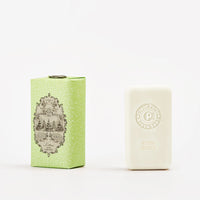 A light green patterned Claus Porto 1887 Classico Spring Lettuce Soap box stands by a white bar enriched with pistachio nut seed oil, embossed with "Claus Porto Butter Lettuce," on a plain white background.
