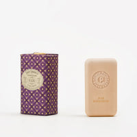 A rectangular bar of Claus Porto 1887 Classico 8741 Pear Sandalwood Soap sits next to its ornate purple and gold packaging, adorned with a vintage-style label.