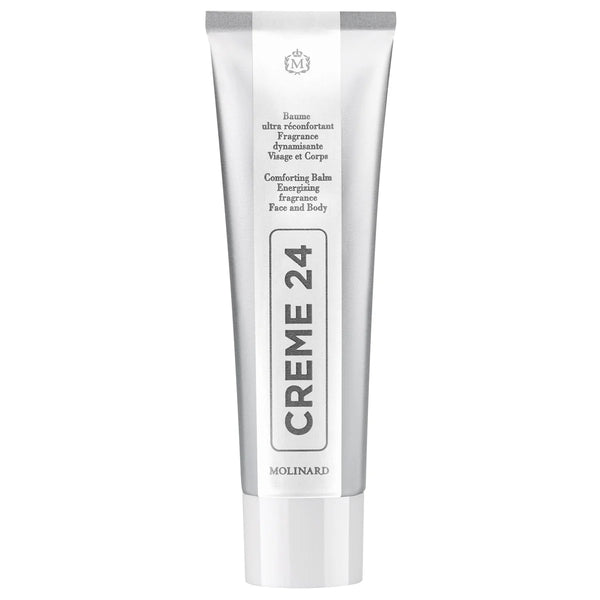 Molinard Creme 24 is a silver and white tube from Molinard, a comforting, energizing balm for face and body with shea butter. Bilingual French and English product details are featured on the packaging.