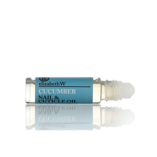 A small, cylindrical bottle of elizabeth W Botanical Apothecary Cucumber Nail & Cuticle Oil with a rollerball applicator. The bottle has a light blue label with black text and contains nourishing botanical oils. The clear liquid within is part of the elizabeth W Botanical Apothecary line, beautifully photographed against a white background.