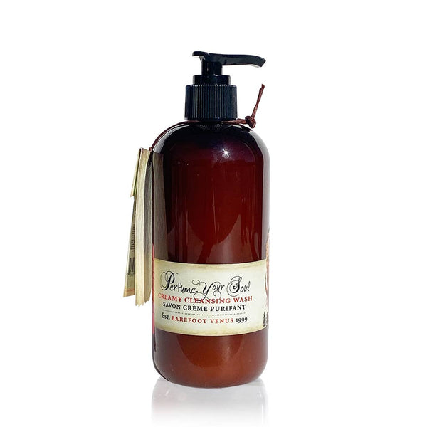 A brown pump bottle labeled "Barefoot Venus Pink Pepper Body Wash & Shower Gel" by Barefoot Venus, a plant-based, cruelty-free body wash, with a small booklet attached to the neck.