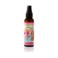 A bottle labeled "Barefoot Venus" contains Barefoot Venus Coconut Kiss Multi-Tasker Body+Bath+Massage Oil - Mini made from plant-based ingredients. The label features an illustration of a woman in a blue dress surrounded by pink flowers with the text "Lily Pilly" and "Peach Kiss." The bottle has a black pump top.