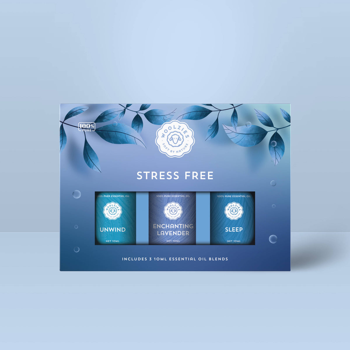 A blue Woolzies Stress Free Collection box with leaf designs holds three 10ml calming oils: Unwind, Enchanting Lavender, and Sleep—Woolzies’ natural relaxation essentials.