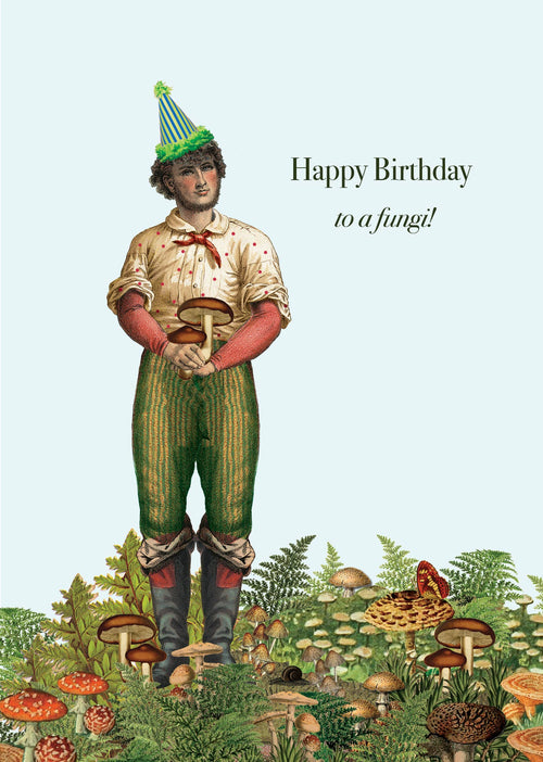 A man in green pants and a party hat stands among mushrooms on this eco-friendly "Happy Birthday to a fungi!" card—by P. Flynn Design / Phun House, perfect for sustainable celebrations.