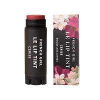 A tube of FRENCH GIRL - Tinted Lip Balm | Cerise rests beside its floral box, both adorned with white text. This vegan balm from FRENCH GIRL provides a hydrating treatment and a deep red tint for your lips.