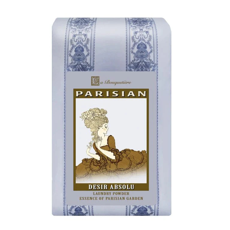 La Bouquetiere Desir Absolu Laundry Powder by La Bouquetiere comes in a pastel blue and white box with vintage-inspired artwork of a woman in an ornate dress, accented by gold and floral borders. Gentle on sensitive skin.