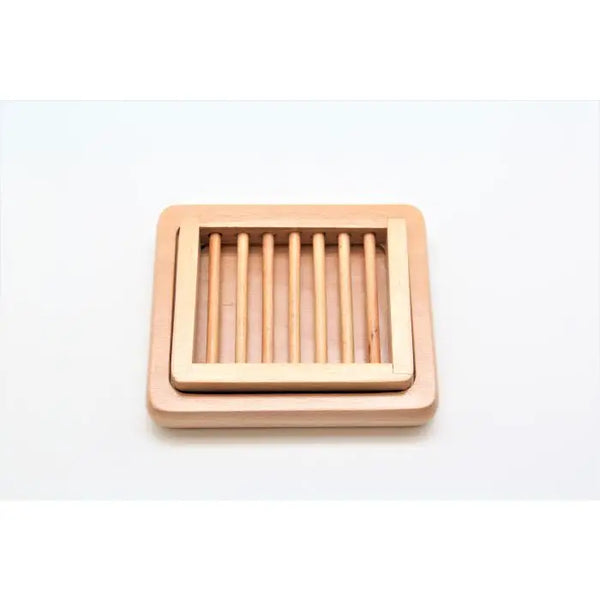 The French Soaps Double Layer Wooden Soap Dish features a slatted, double-layer design with a raised border to help prolong your soap's life. Perfect for any bathroom, from the trusted brand French Soaps. Displayed on a white background.