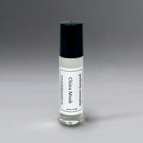 A small glass bottle with a black cap labeled "Perfectly Scentsable China Musk Perfume Oil - Rollerball," containing 0.33 oz (10 ml) of liquid. This timeless, gender-neutral fragrance stands upright against a gradient gray background.