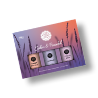 The Woolzies Calm & Peaceful Collection is a boxed set of three blends—Sweet Dreams, Unwind, and Stress Erase—with a purple-orange gradient and lavender art. Perfect for calm and restful sleep. Text: "Calm & Peaceful." Brand: Woolzies.