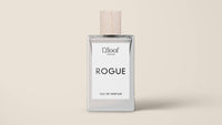 A minimalist perfume bottle featuring a wooden cap and a white label. The label displays "L'floof LONDON" at the top and showcases "ROGUE" prominently in bold letters across the middle, capturing the essence of L'floof ROGUE Dog Perfume Fragrance Spray. At the bottom, it reads "EAU DE PARFUM." The background is a plain beige color.