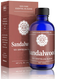 A blue bottle of Woolzies Sandalwood Essential Oil stands before its brown box, both featuring the Woolzies branding and product info, known for a soothing aroma and benefits for skin health.