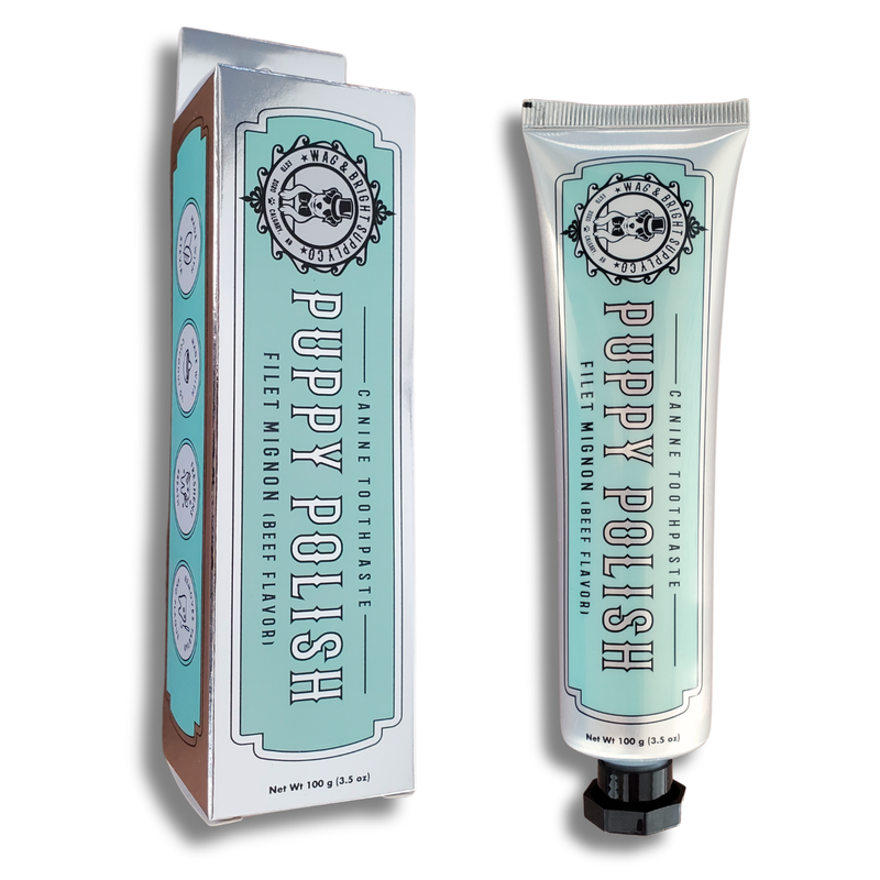 Wag & Bright Supply Co. offers their Puppy Polish Toothpaste in a filet mignon beef flavor, featuring light blue packaging with vintage-style text and design elements. Crafted with natural ingredients for your pet's health, this oral care solution ensures superior dental hygiene for your canine.