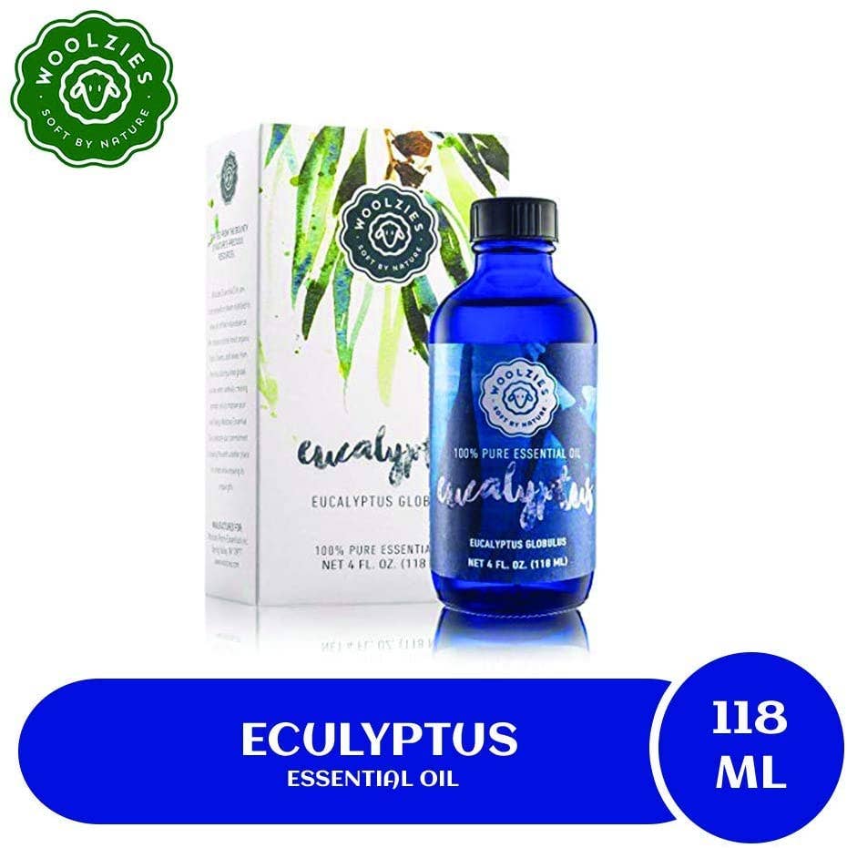 A blue bottle of Woolzies Eucalyptus Essential Oil is shown beside its box with green leaves, featuring the product name and 118 ml size—an excellent natural cleaning agent that also supports respiratory health.