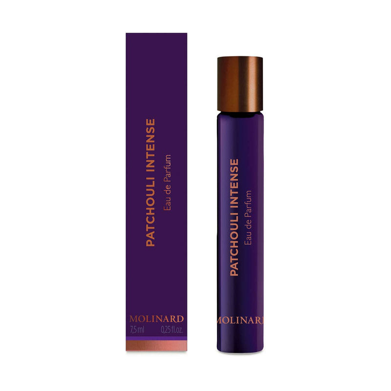 A tall, slim purple Molinard Patchouli Intense Eau de Parfum Roll-On bottle with gold text stands beside its matching box. This gourmand scent by Molinard contains 7.5 ml (0.25 fl oz) and is labeled "Patchouli Intense Eau de Parfum.