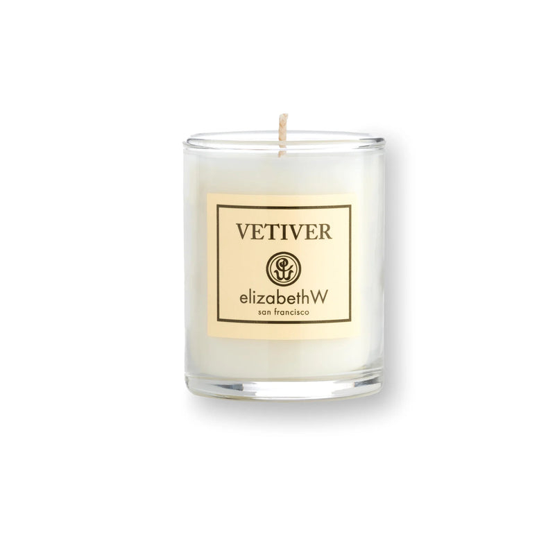 A elizabeth W Vetiver Candle - Petite, featuring a cream-colored soy wax in a clear glass jar with a label marked "vetiver" and the elizabeth W logo, on a white background.