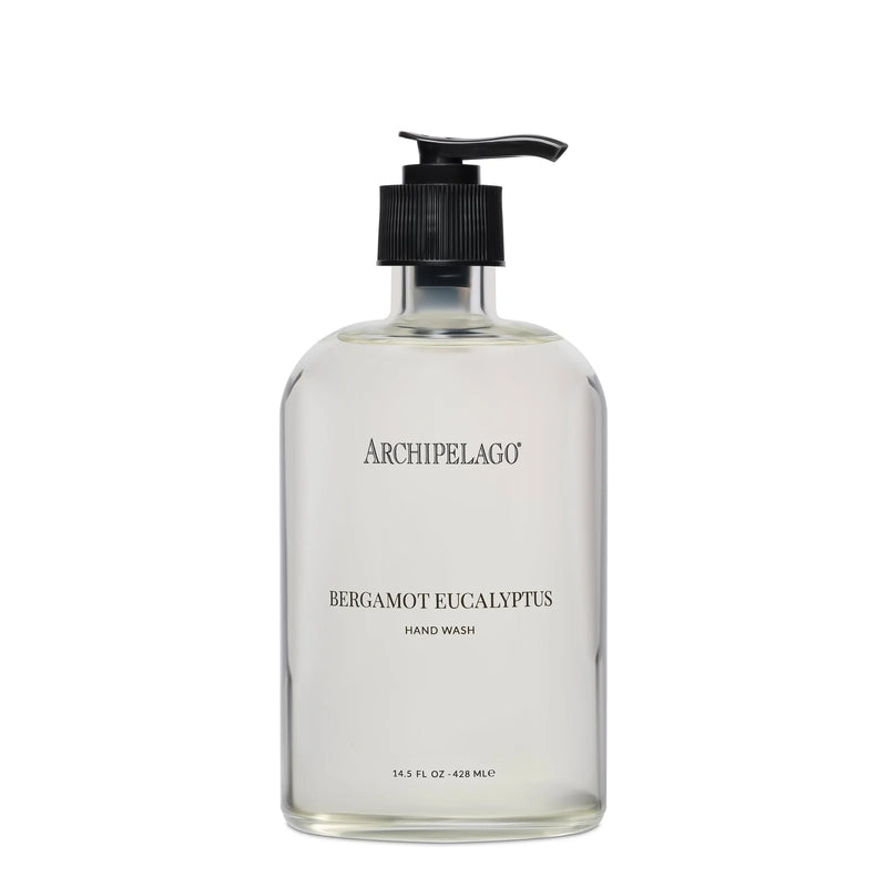 A clear glass pump bottle labeled "Archipelago Botanicals Bergamot Eucalyptus Glass Hand Wash" holds 14.5 fl oz (428 ml) of plant-based liquid soap. The simple label has black text on a transparent background from Archipelago Botanicals.